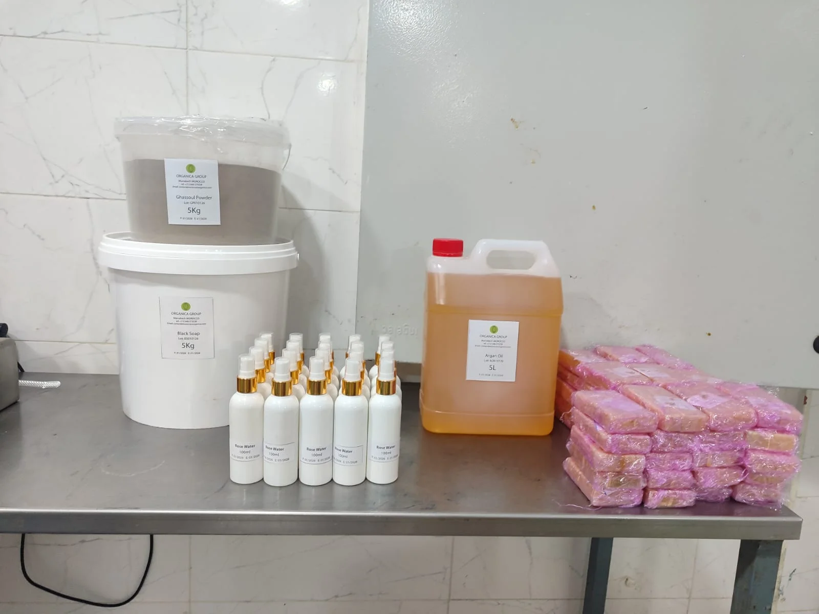 Private label production run of pink and blue clay jars with gold lids